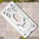 Overhead view of a white outdoor hot tub with multiple jets on a tiled patio.
